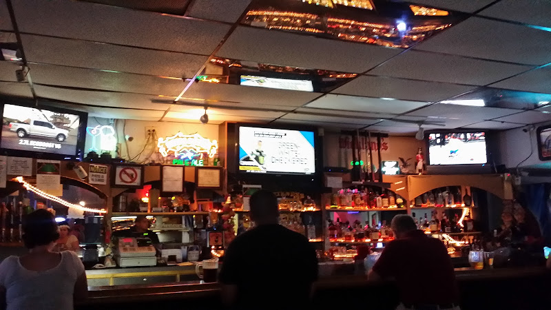 The bar at Time Out Tavern, TVs and neon over the back bar