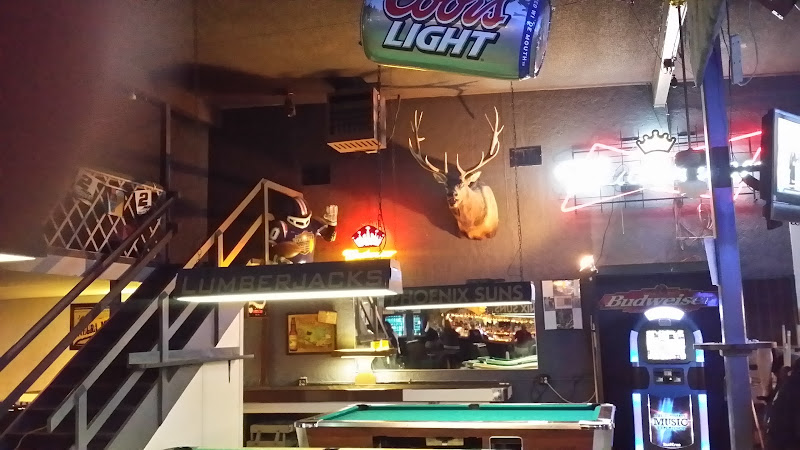 Pool table, jukebox, and sports signs inside Time Out Tavern