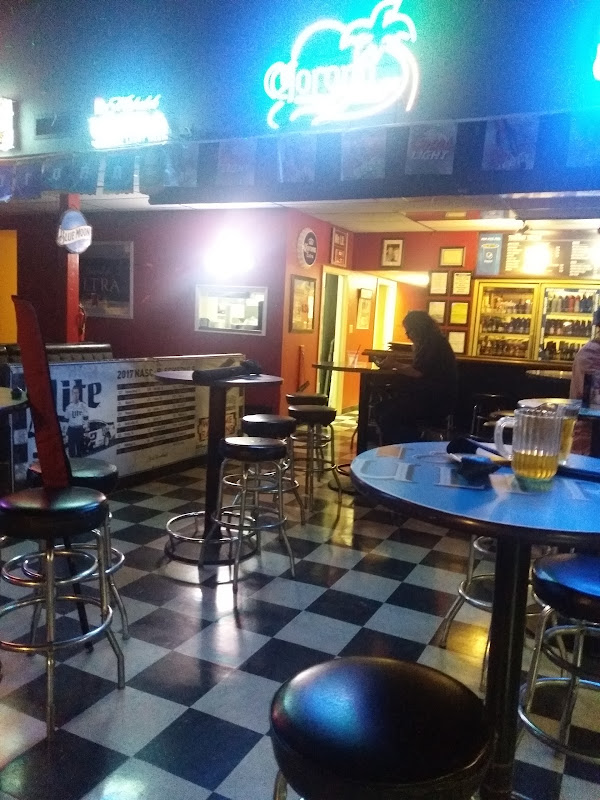 Checkered floor, high-tops, and beer coolers